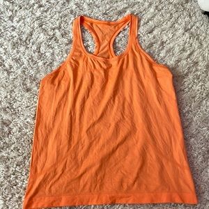 Lululemon racer-back swiftly tech orange top.